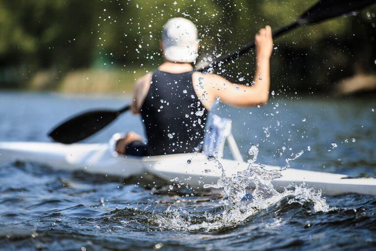Athlete rowing kayak