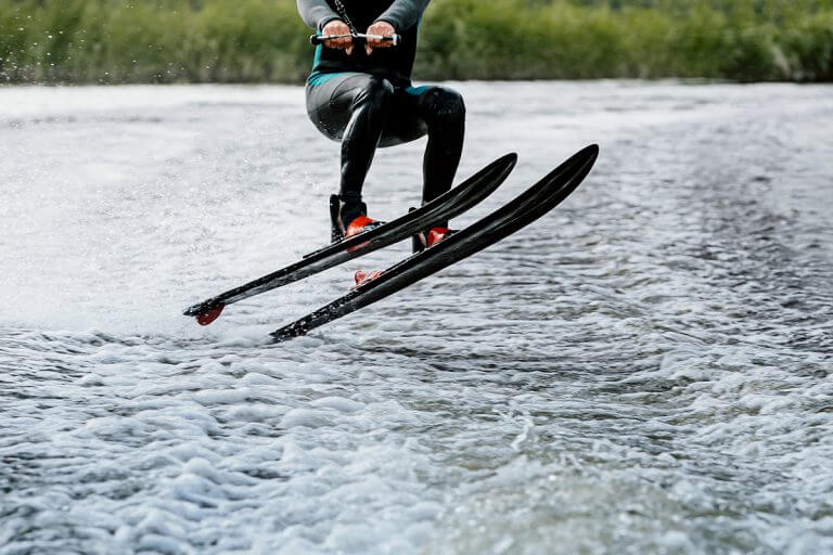 Man waterskiing on lake behind