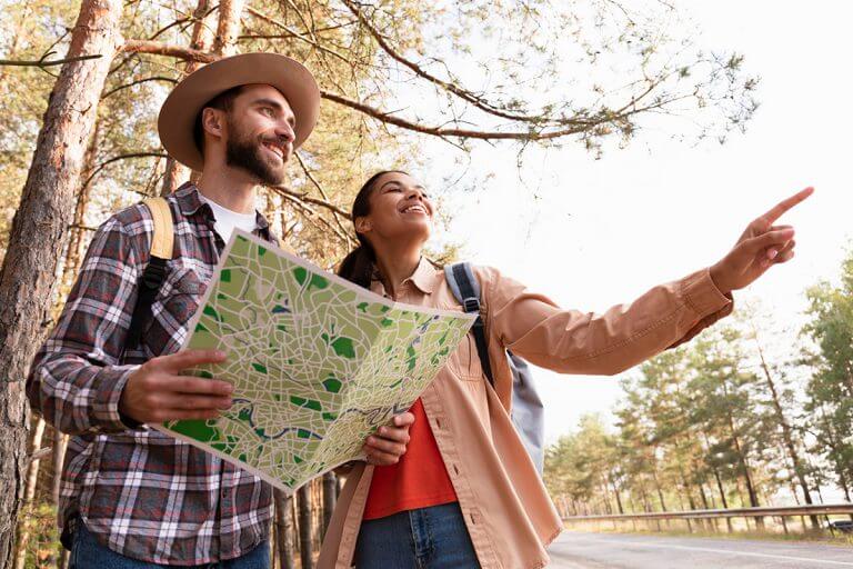 Couple looking same directions while man is holding map