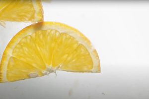 Slices of delicious orange fall down into water